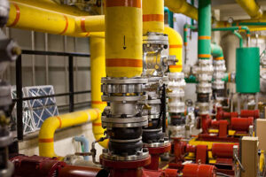 a shot of some pumps and plumbing in a boiler room. shallow d.o.f.