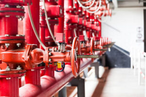 a row of red color fire fighting water supply pipeline system